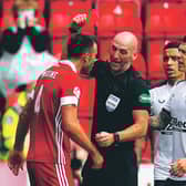 Bobby Madden flashes his red card at Aberdeen defender Andrew Considine. Picture: Andrew Milligan/PA