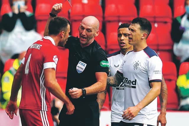 Bobby Madden flashes his red card at Aberdeen defender Andrew Considine. Picture: Andrew Milligan/PA
