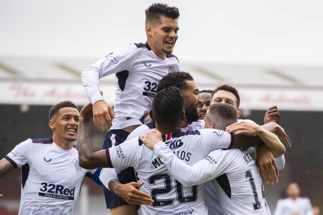 Ryan Kent is engulfed by team-mates after scoring Rangers' winning goal against Aberdeen. Picture: SNS.