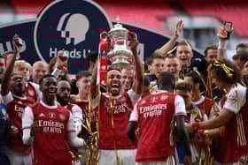 Arsenal captain and man of the match Pierre-Emerick Aubameyang holds the trophy aloft as the Gunners celebrate their victory over Chelsea in Saturday’s FA Cup final at Wembley. AFP/Getty