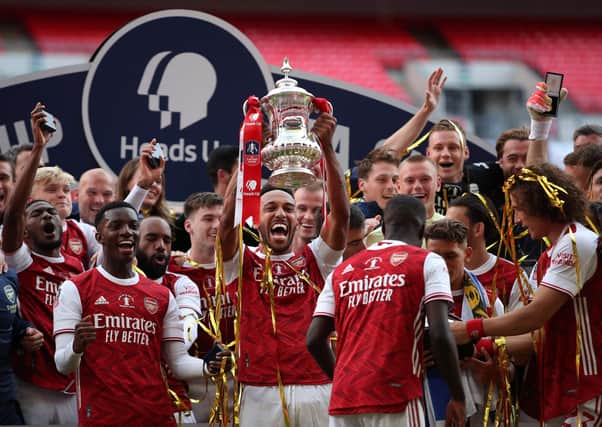 Arsenal captain and man of the match Pierre-Emerick Aubameyang holds the trophy aloft as the Gunners celebrate their victory over Chelsea in Saturday’s FA Cup final at Wembley. AFP/Getty