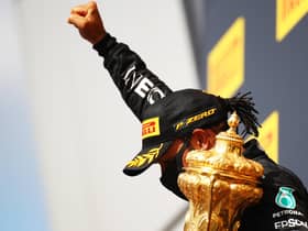 Lewis Hamilton celebrates with a black power salute after winning his seventh British Grand Prix. Picture: Bryn Lennon/Getty Images