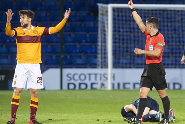 Motherwell’s Callum Lang can’t believe he’s being shown a red card by referee Nick Walsh