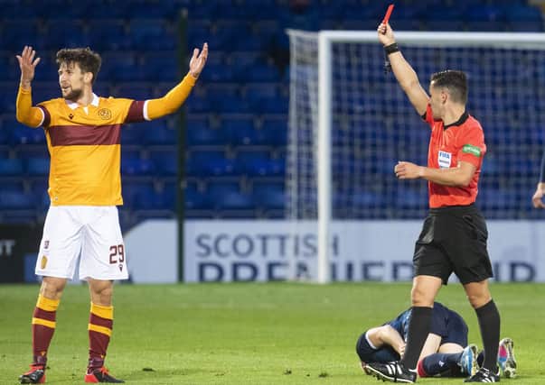 Motherwell’s Callum Lang can’t believe he’s being shown a red card by referee Nick Walsh