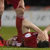 Scott McKenna is injured in Aberdeen's Scottish Cup quarter-final against St Mirren in February