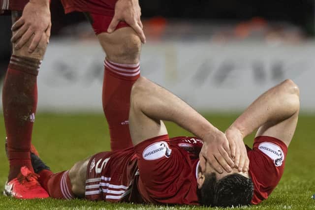 Scott McKenna is injured in Aberdeen's Scottish Cup quarter-final against St Mirren in February