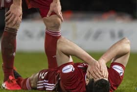 Scott McKenna is injured in Aberdeen's Scottish Cup quarter-final against St Mirren in February