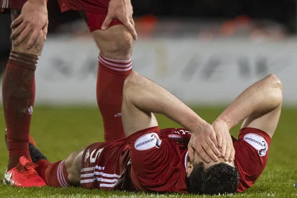Scott McKenna is injured in Aberdeen's Scottish Cup quarter-final against St Mirren in February