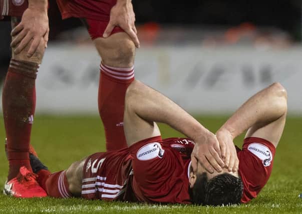 Scott McKenna is injured in Aberdeen's Scottish Cup quarter-final against St Mirren in February