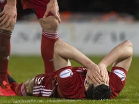 Scott McKenna is injured in Aberdeen's Scottish Cup quarter-final against St Mirren in February