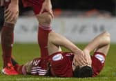 Scott McKenna is injured in Aberdeen's Scottish Cup quarter-final against St Mirren in February