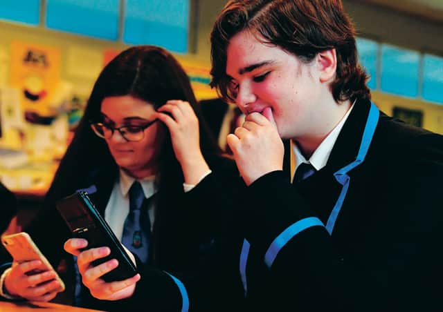 Students at Lourdes Secondary School receive their exam results by text