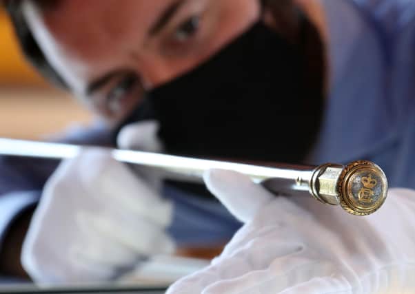 Colin Fraser consultant specialist holds a walking cane believed to have belonged to Prince Charles Edward Stuart