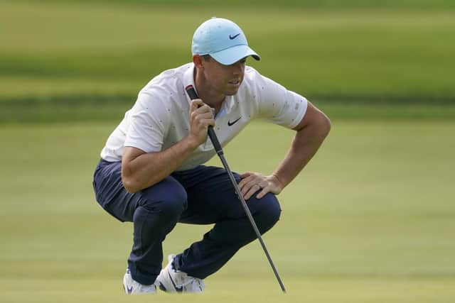Rory McIlroy lines up a putt on the first green during the first round of the US Open. Picture: John Minchillo/AP