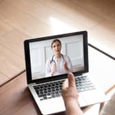 An older man talks with a doctor by video call