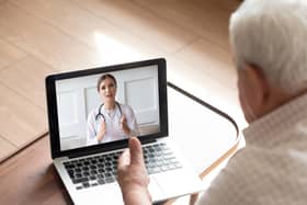 An older man talks with a doctor by video call