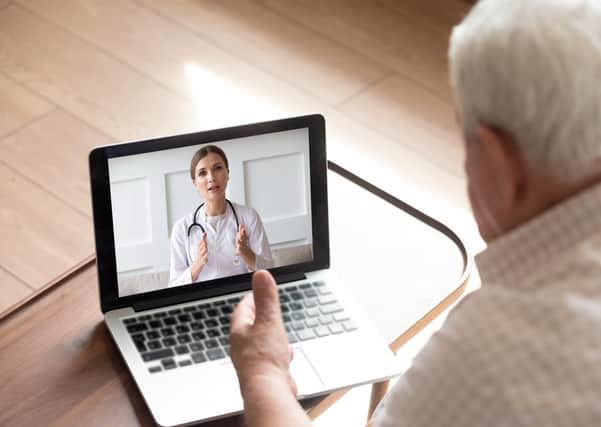 An older man talks with a doctor by video call