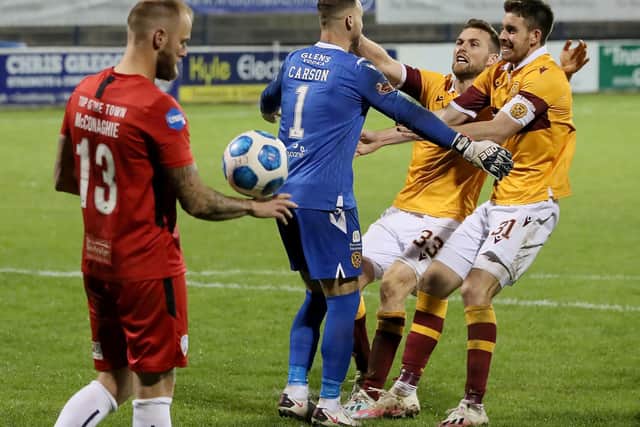 Stephen O'Donnell and Declan Gallagher rush to congratulate Trevor Carson after the keeper's penalty shootout heroics for Motherwell. Picture: Brian Lawless/PA Wire