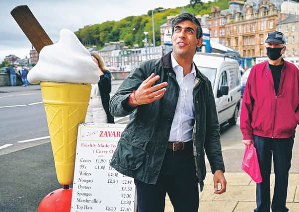 Chancellor of the Exchequer Rishi Sunak meets with local business people during a visit on the Isle of Bute on August 07, 2020