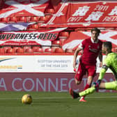 Christopher Long strokes the ball past Joe Lewis following the keeper’s poor clearance. Picture: SNS.