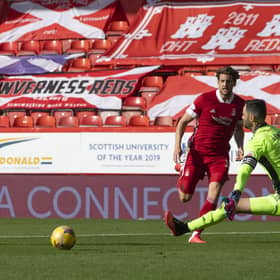 Christopher Long strokes the ball past Joe Lewis following the keeper’s poor clearance. Picture: SNS.