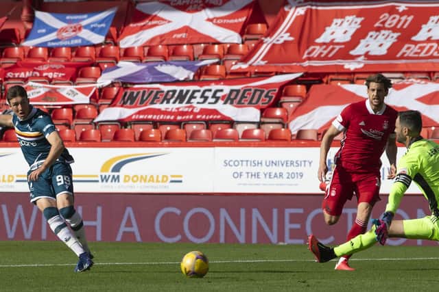 Christopher Long strokes the ball past Joe Lewis following the keeper’s poor clearance. Picture: SNS.