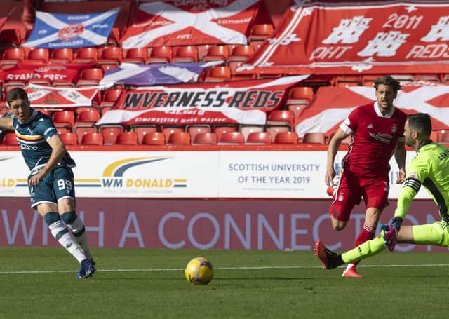 Christopher Long strokes the ball past Joe Lewis following the keeper’s poor clearance. Picture: SNS.