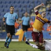 Motherwell forward Tony Watt is tackled by Hapoel's opening scorer Miguel Vitor. Picture: Ariel Schalit/AP