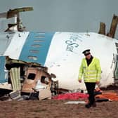 A policeman walking nearby the cockpit of the 747 Pan Am Boeing that exploded, killing all 259 on board and 11 on the ground.