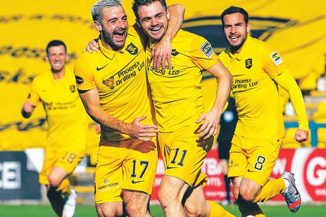 Livingston scorer Alan Forrest (11) celebrates with Scott Robinson. Picture: Ross Parker/SNS Group