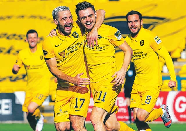 Livingston scorer Alan Forrest (11) celebrates with Scott Robinson. Picture: Ross Parker/SNS Group