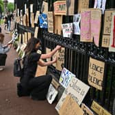 Black Lives Matter protesters hang their banners on the fence of Holyrood Palace. Picture: Jeff J Mitchell/Getty Images