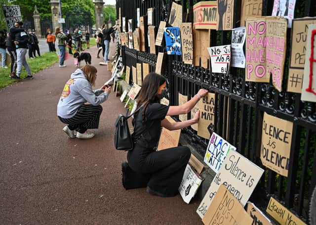 Black Lives Matter protesters hang their banners on the fence of Holyrood Palace. Picture: Jeff J Mitchell/Getty Images