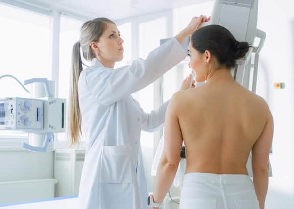 A female patient undergoes a mammogram