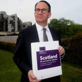 Sustainable Growth Commission chair Andrew Wilson outside the Scottish Parliament with its report. (Picture: Gordon Terris/The Herald/PA Wire