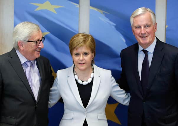 European Commission President Jean Claude Juncker (L) and EU chief Brexit negotiator Michel Barnier (R) receive Scotland's First Minister Nicola Sturgeon at the European Commission Headquarters on June 11, 2019