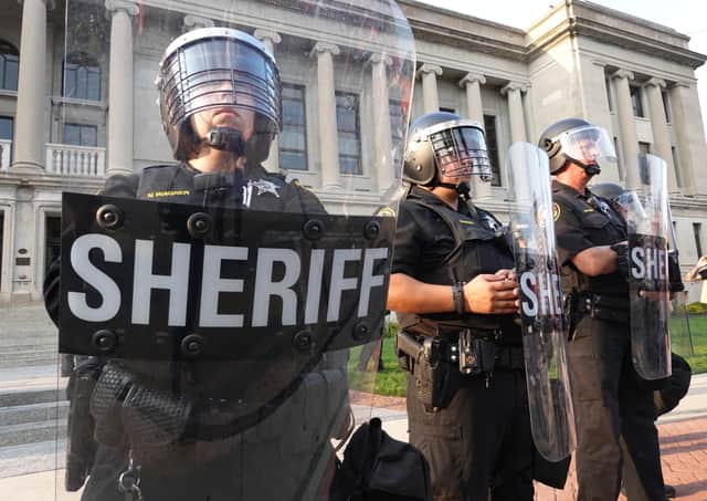 Police stand guard in front of the Kenosha County Courthouse during a second day of unrest on August 24, 2020 in Kenosha, Wisconsin.