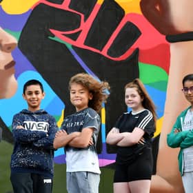 Members of the Govanhill Youth Group in front of the new mural they helped design..