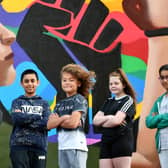 Members of the Govanhill Youth Group in front of the new mural they helped design.
.