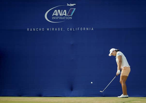Mirim Lee plays her pitch to the 18th green after  using the blue wall as a backstop. Picture: Getty