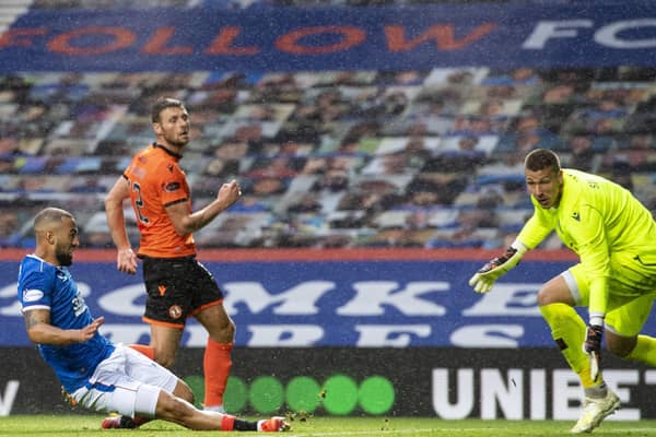 Striker Kemar Roofe  scores the third in Rangers' 4-0 win over  Dundee United at Ibrox.