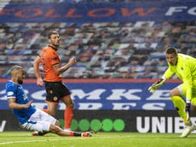 Striker Kemar Roofe  scores the third in Rangers' 4-0 win over  Dundee United at Ibrox.