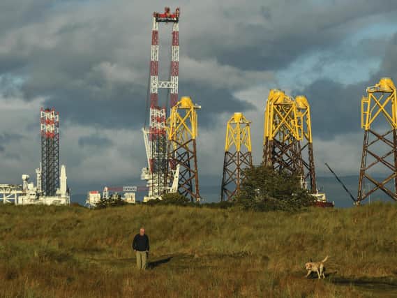Foundations for an offshore wind farm float in The Cromarty Forth. Locals are accustomed to the sight of oil rigs moored up for maintenance, but moves to more renewables will transform the area, and the Scottish economy. Picture: Getty Images