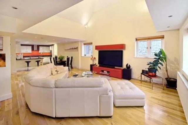 The open plan dual aspect living area has a vaulted ceiling and solid oak flooring