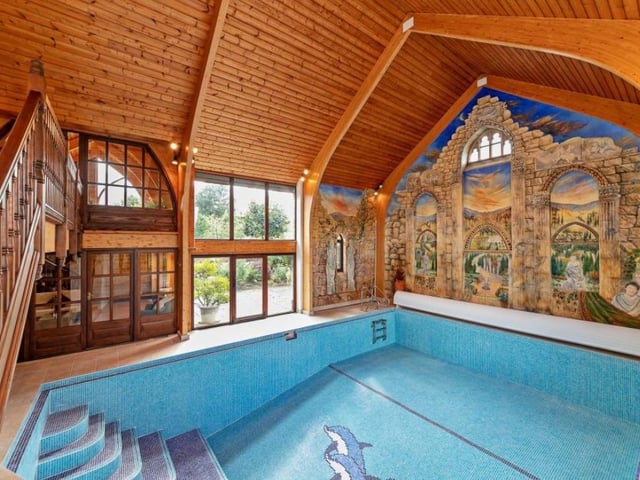 The split grand central staircase leads to the first floor with access half way to the swimming pool terrace and sauna at the home in Litchborough