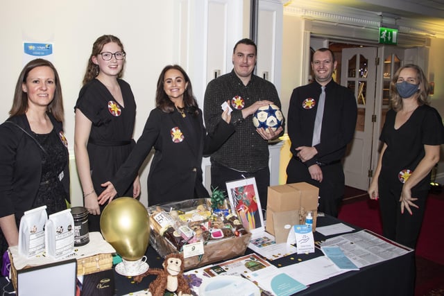 4Sight Vision Support staff and volunteers show off some of the ball raffle prizes, from left to tight: Julie Branson, fundraising manager; Jessica Passmore, marketing and communications officer/community fundraiser; Amy Bunn, volunteer; Miles Townsend, fundraising officer; Darren Saich, volunteer; and Tina Mansfield, fundraising assistant