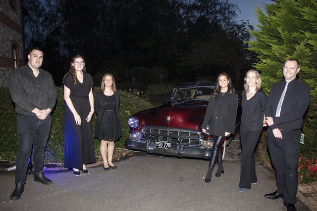 4Sight Vision Support team - Miles Townsend, fundraising officer; Jessica Passmore, marketing and communications officer/community fundraiser; Julie Branson, fundraising manager; Amy Bunn, volunteer; Tina Mansfield, fundraising assistant and Darren Saich, volunteer - pose by a 1949 Cadillac Coupe De Ville
