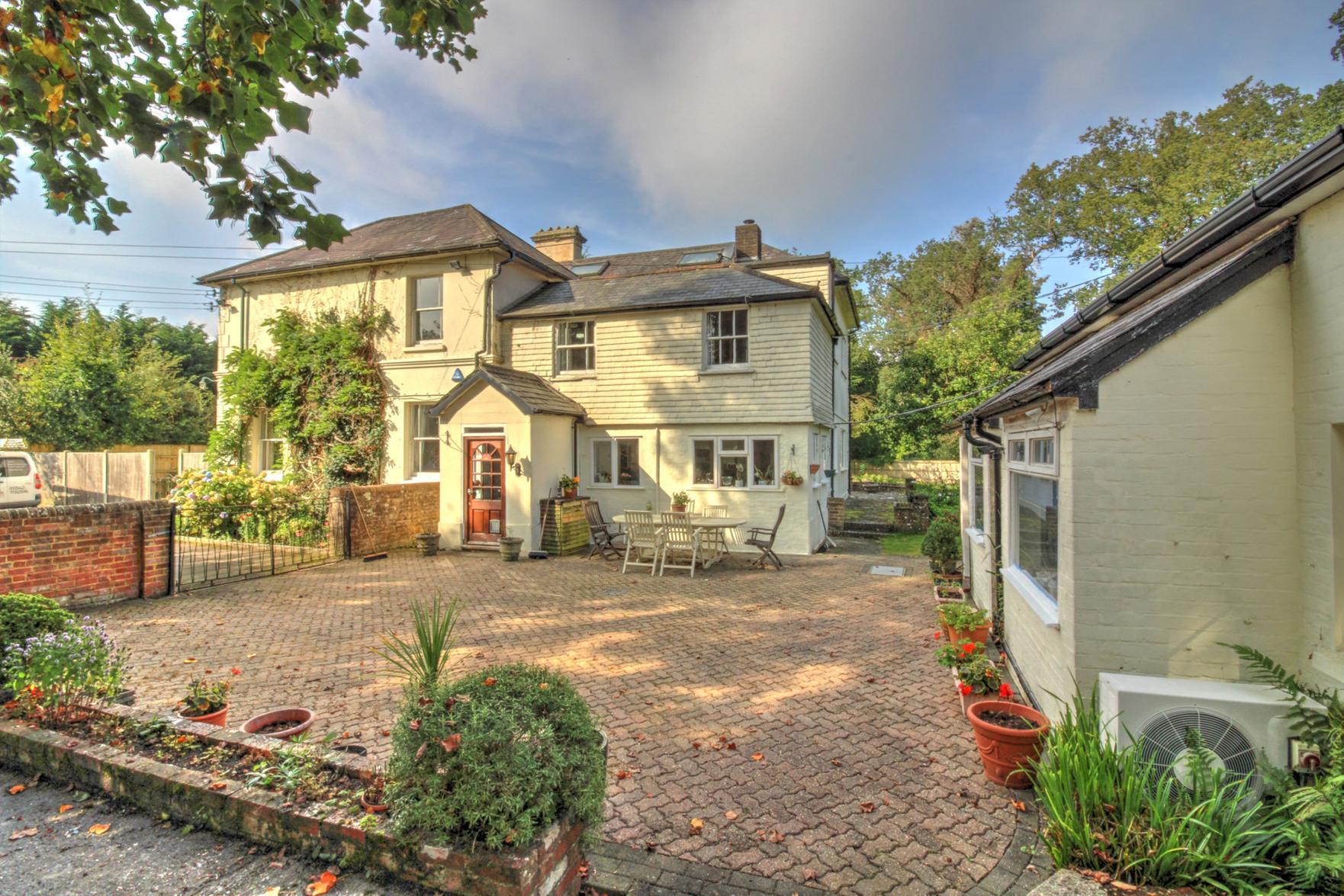 The property has an extensive driveway behind double gates