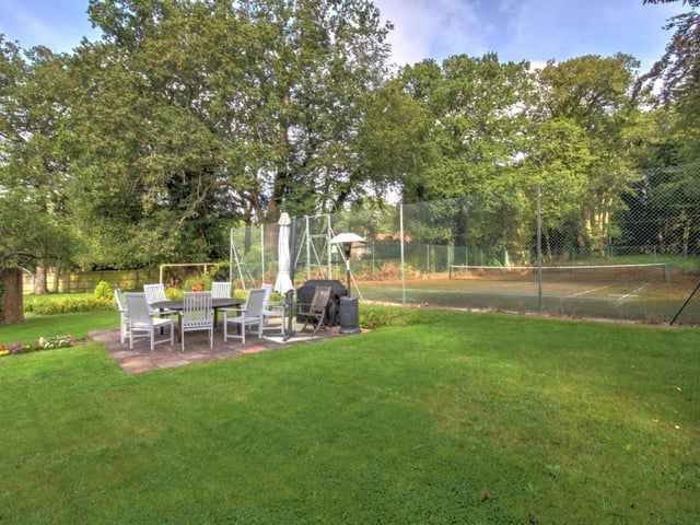 Approx 1.2 acres of garden which includes a tennis court