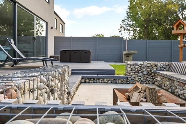 The property boasts a  turfed rear garden, hybrid resin decking and fencing, as well as a barbecue area and Gabion stone fire pit seating areas. Picture: Mishon Mackay.